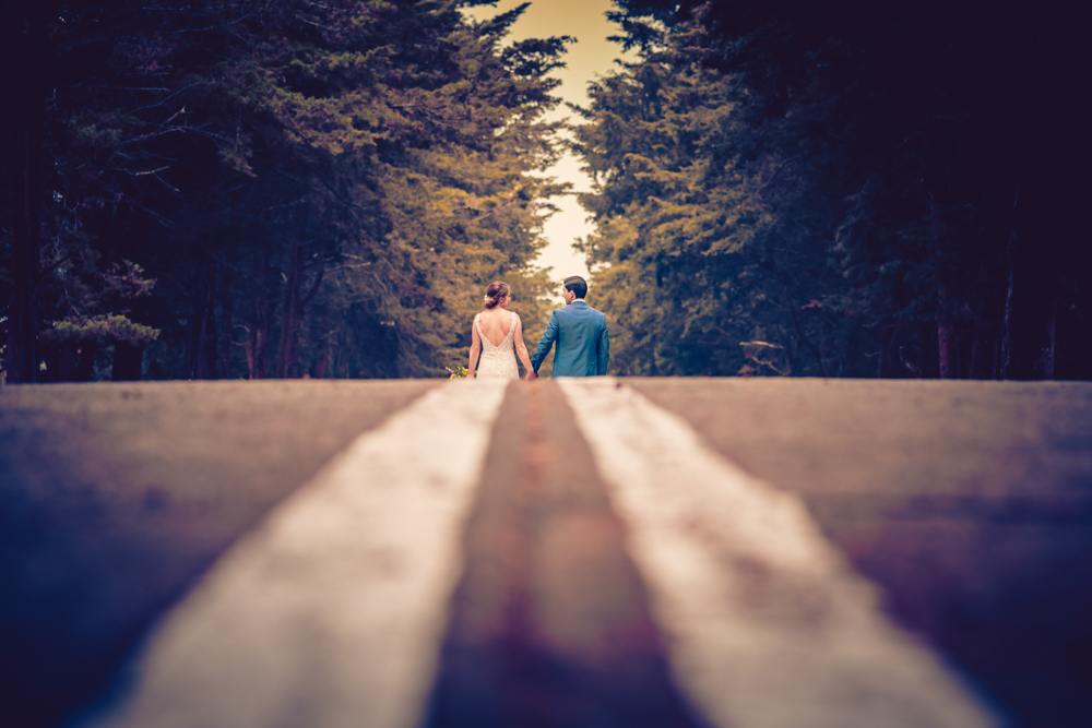 antigua guatemala wedding photographer- bride and groom walking with forest